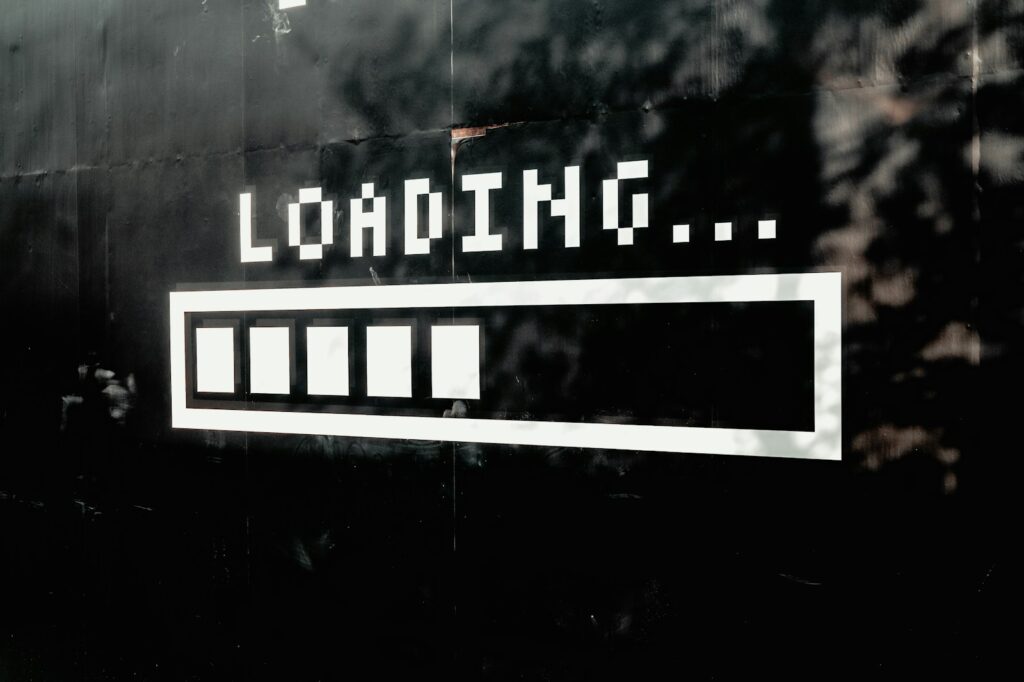 A white loading bar with five filled segments on a black wall